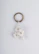 A custom 3D printed keyring featuring intricate details and a shiny finish.