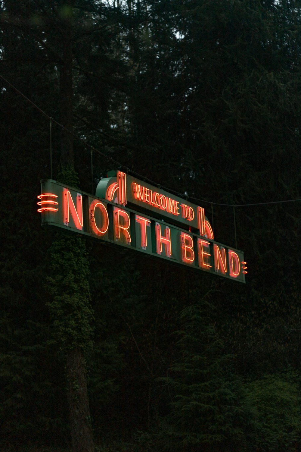 a neon sign that reads welcome to north bend