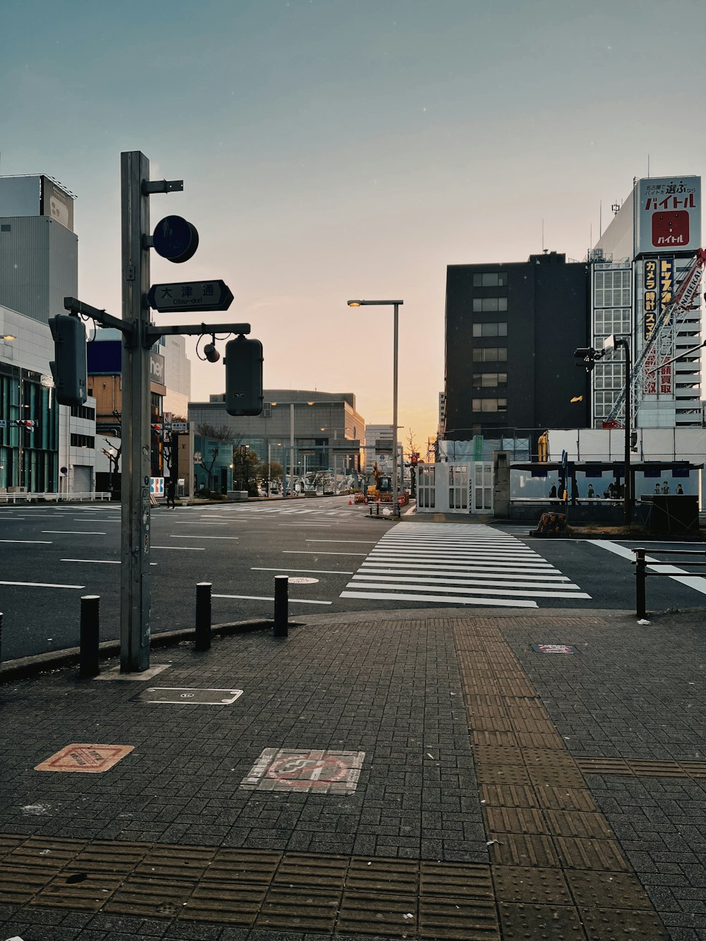 a city street with a crosswalk and street signs