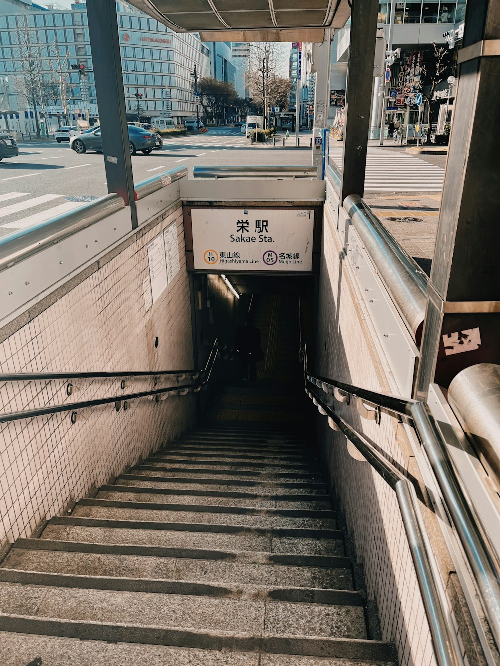 a set of stairs leading up to a subway station