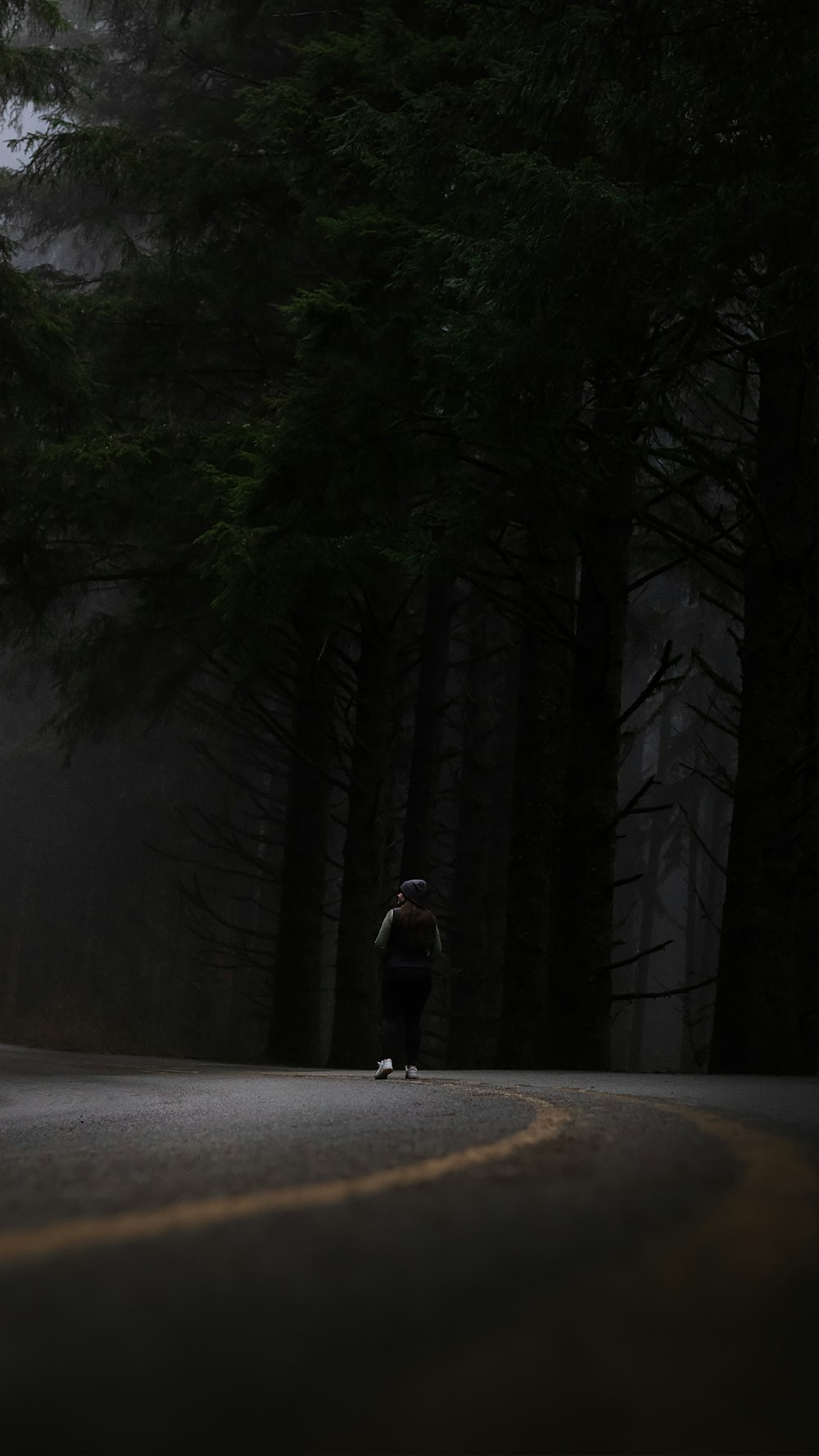 a person riding a skateboard down a dark road