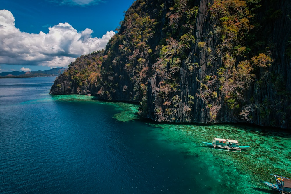 a group of boats floating on top of a body of water