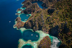 an aerial view of a tropical island with a lagoon