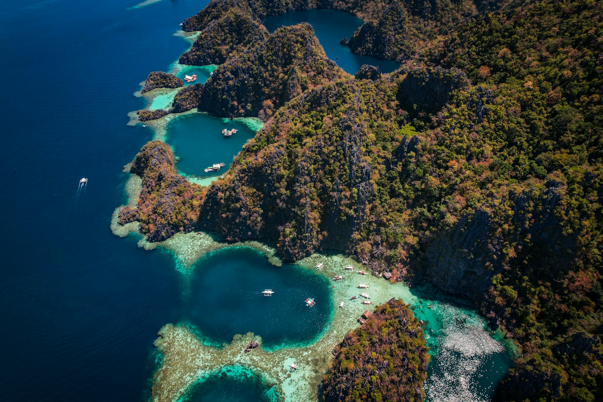 an aerial view of a tropical island with a lagoon