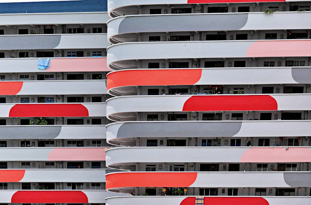 a group of multicolored buildings with a clock on each of them