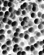 a black and white photo of a bunch of balls