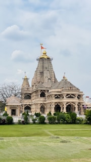 a large building sitting on top of a lush green field