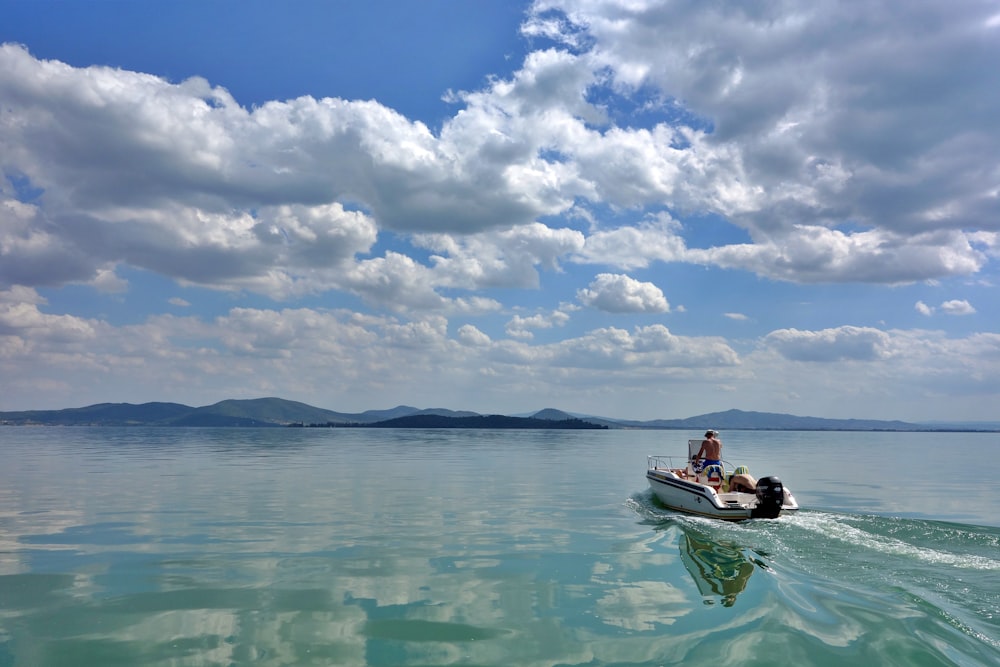 a man riding on the back of a small boat