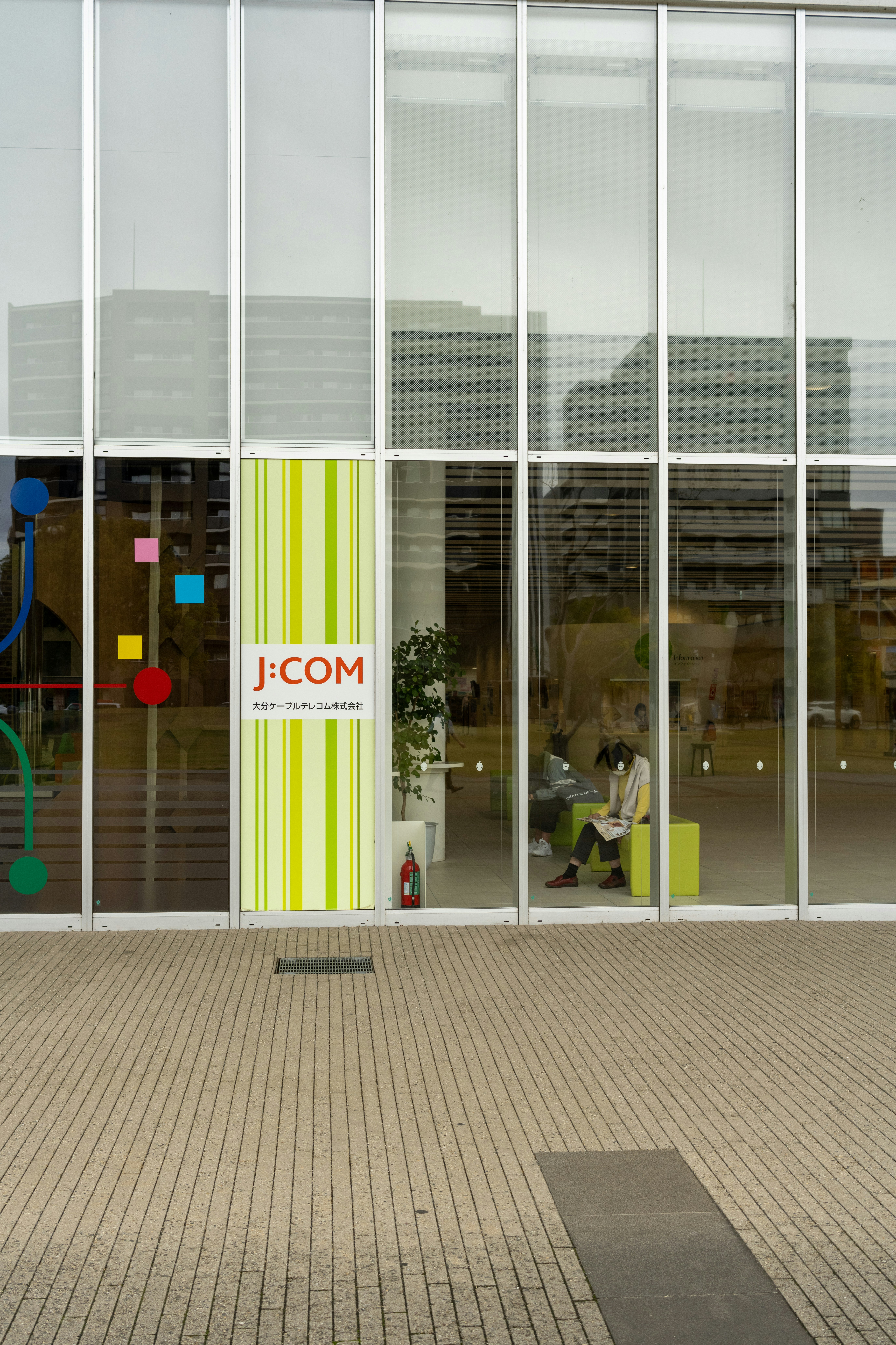 a person sitting on a bench in front of a building
