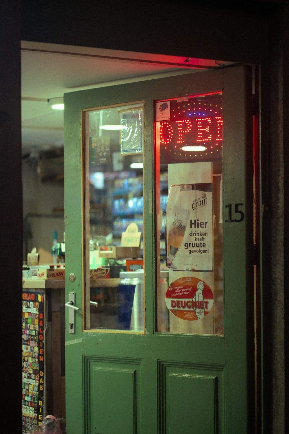 a green door with a sign on it