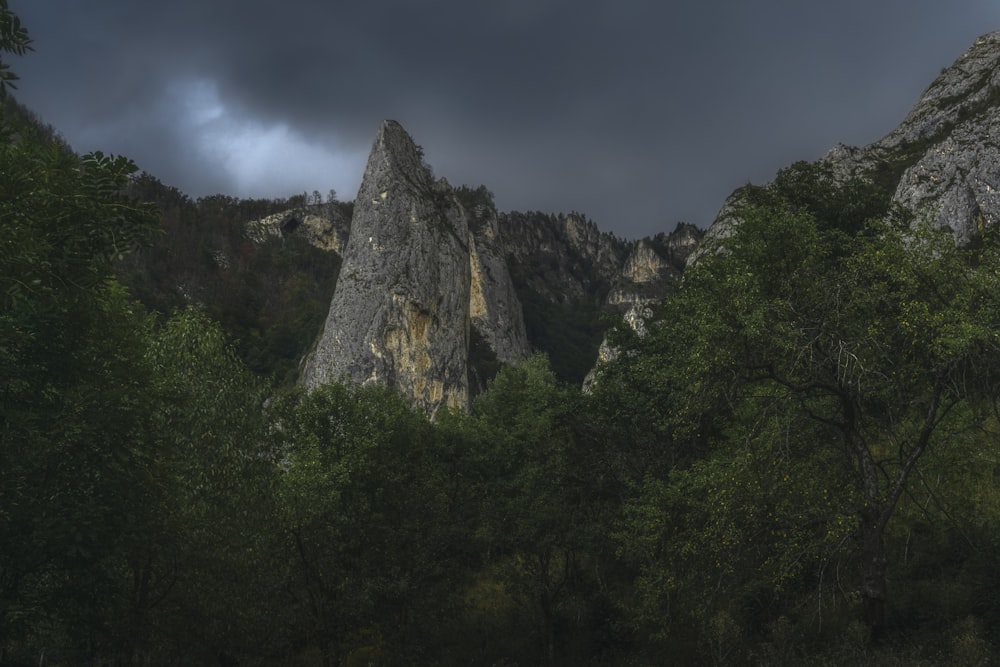 a mountain with a dark sky in the background