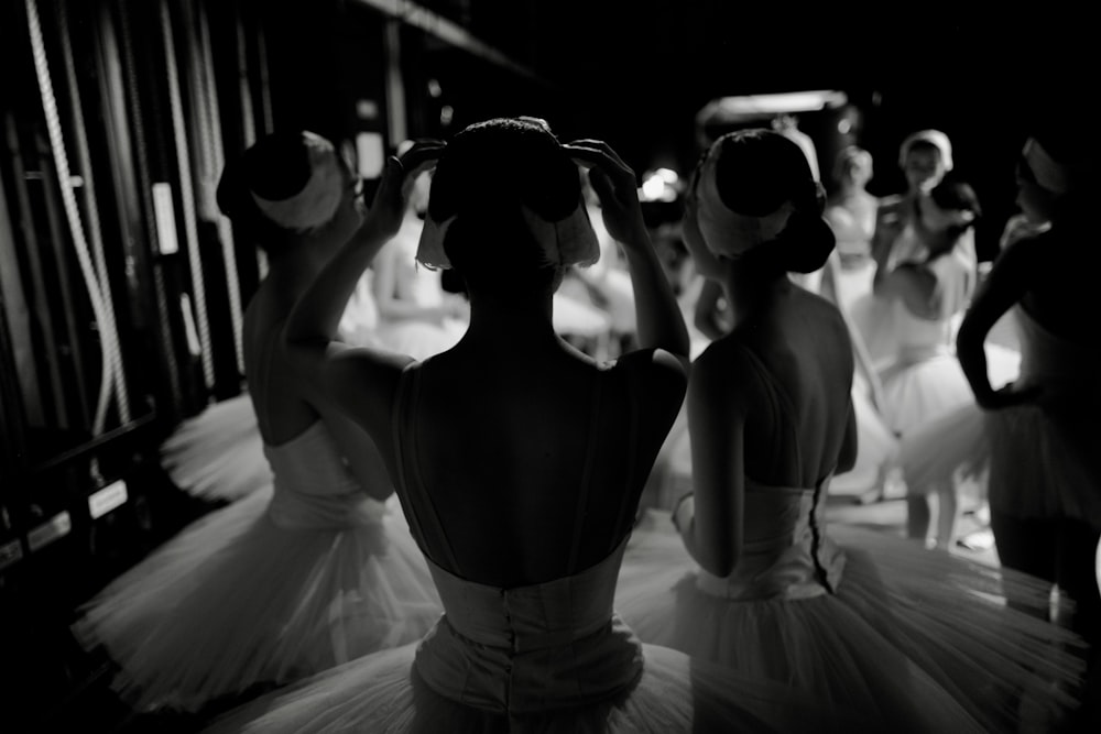 a black and white photo of a group of ballerinas