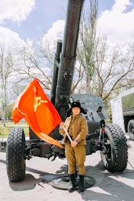 An artistic Roblox depiction of the Psovskiy Pekhotniy Polk marching under a bright yellow and red banner.