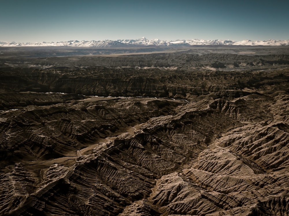 a view of a mountain range with snow capped mountains in the distance