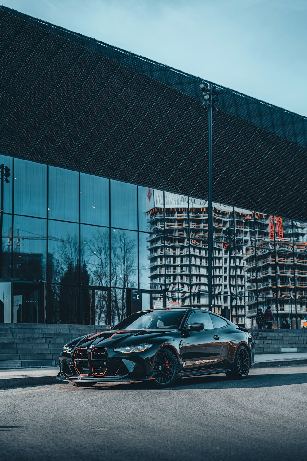 a black sports car parked in front of a building