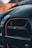Close-up view of the front grille of a luxury sports car with the 'M4 CSL' emblem prominently displayed. The exterior reflects a sleek and modern aesthetic with accents of orange outlining the design.