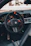 Close-up of a futuristic vehicle dashboard with sleek metallic gray and orange accents.