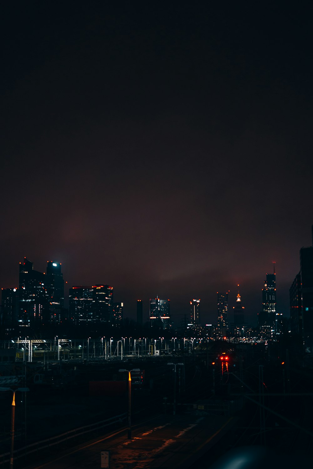 a city skyline at night with the lights on