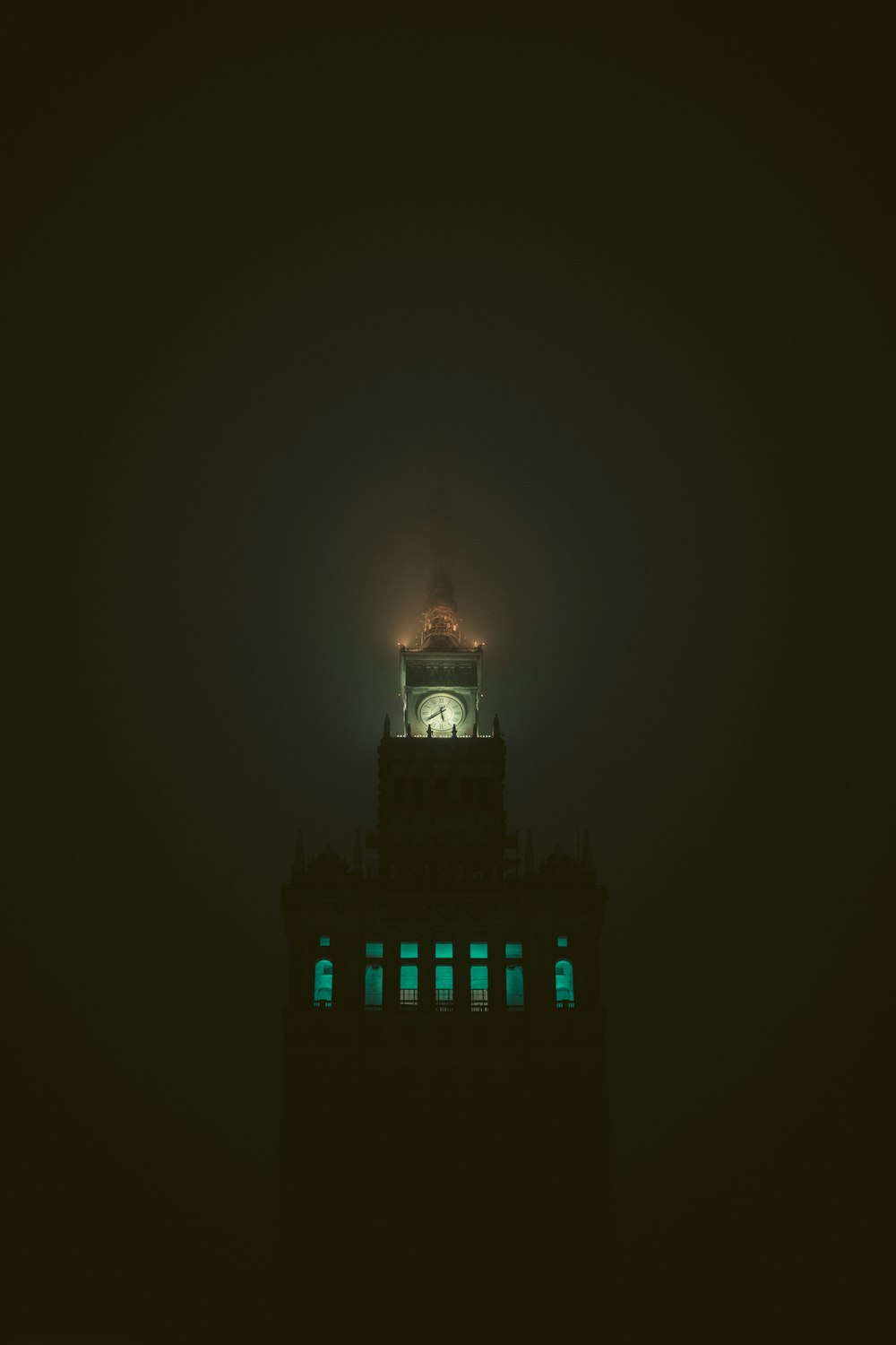a clock tower lit up in the dark