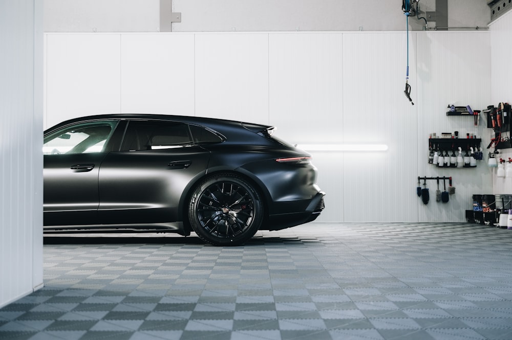 a black sports car parked in a garage