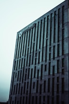 A tall, modern building with vertical lines and numerous windows. The building features a logo and the name 'northmill' at the top, set against a pale sky.