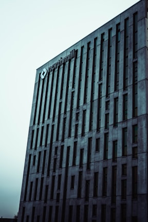 A tall, modern building with vertical lines and numerous windows. The building features a logo and the name 'northmill' at the top, set against a pale sky.