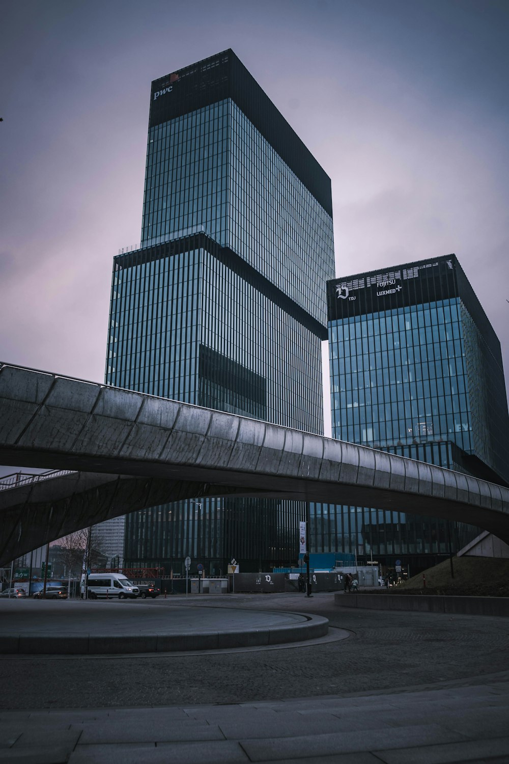 a very tall building sitting next to a bridge