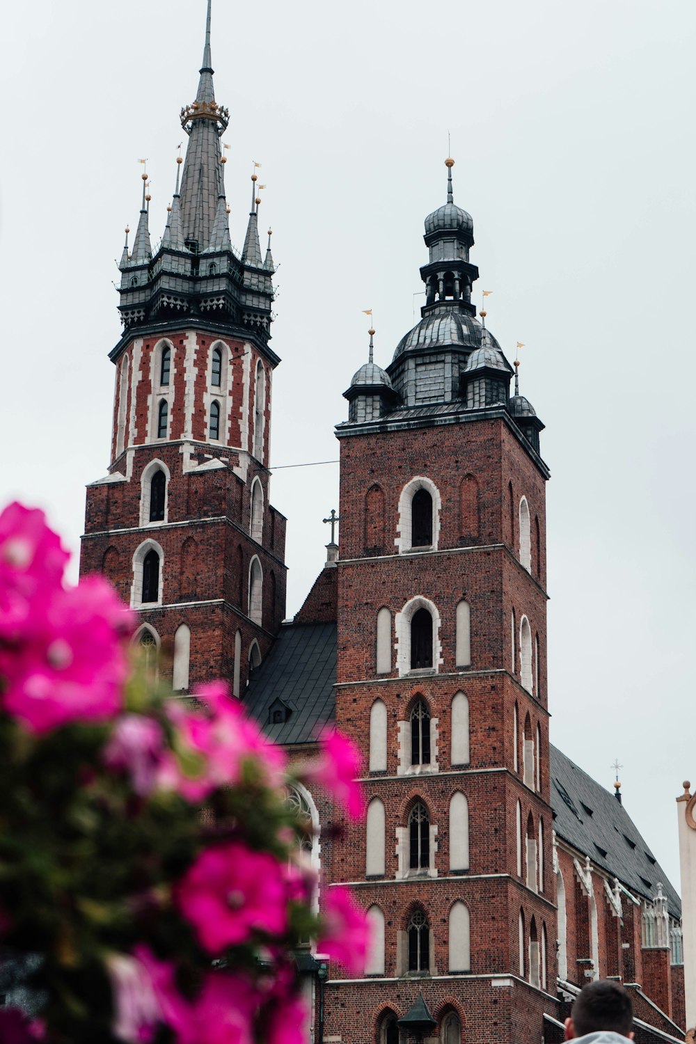 a large brick building with two towers and a clock