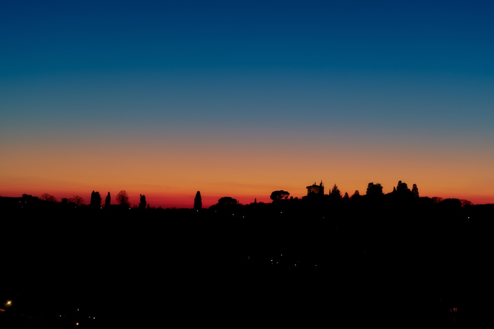 a view of a city at sunset from a hill