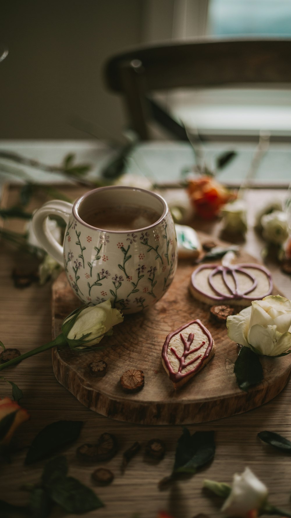 a cup of tea sitting on top of a wooden cutting board