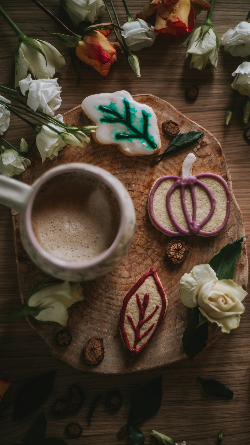 a cup of coffee and some cookies on a plate