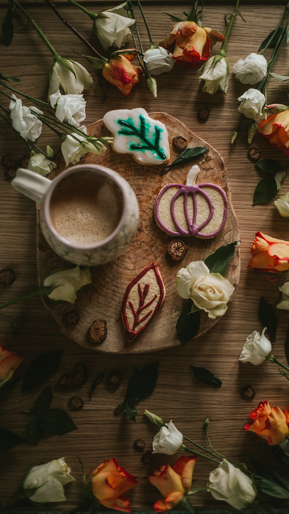 a cup of coffee and some cookies on a plate