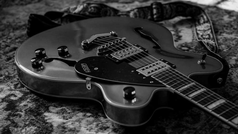 a black and white photo of an electric guitar