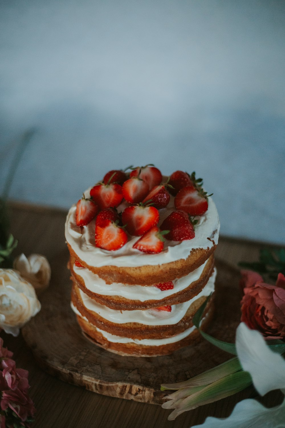 a close up of a cake with strawberries on top