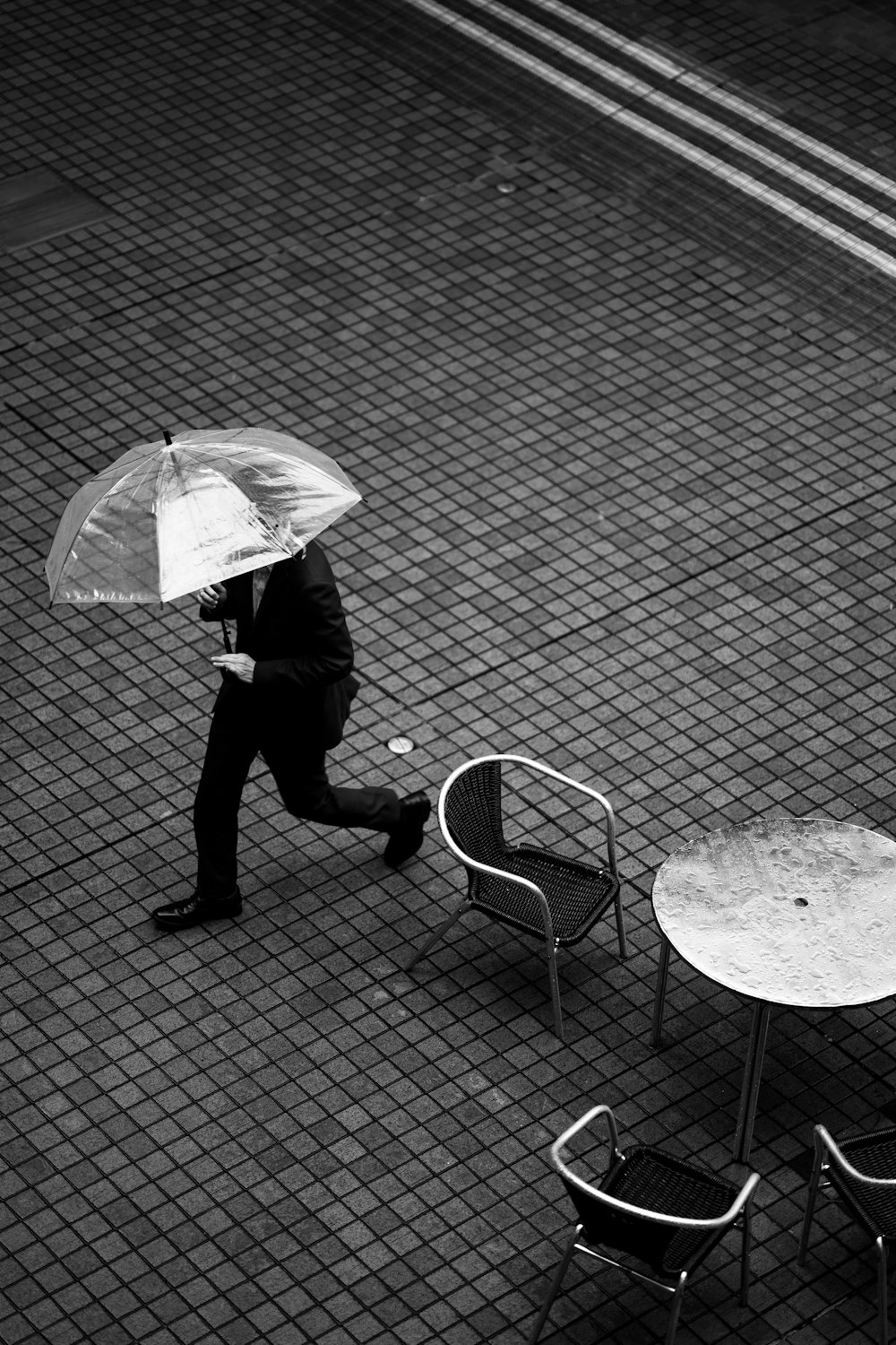 a person walking with an umbrella over their head