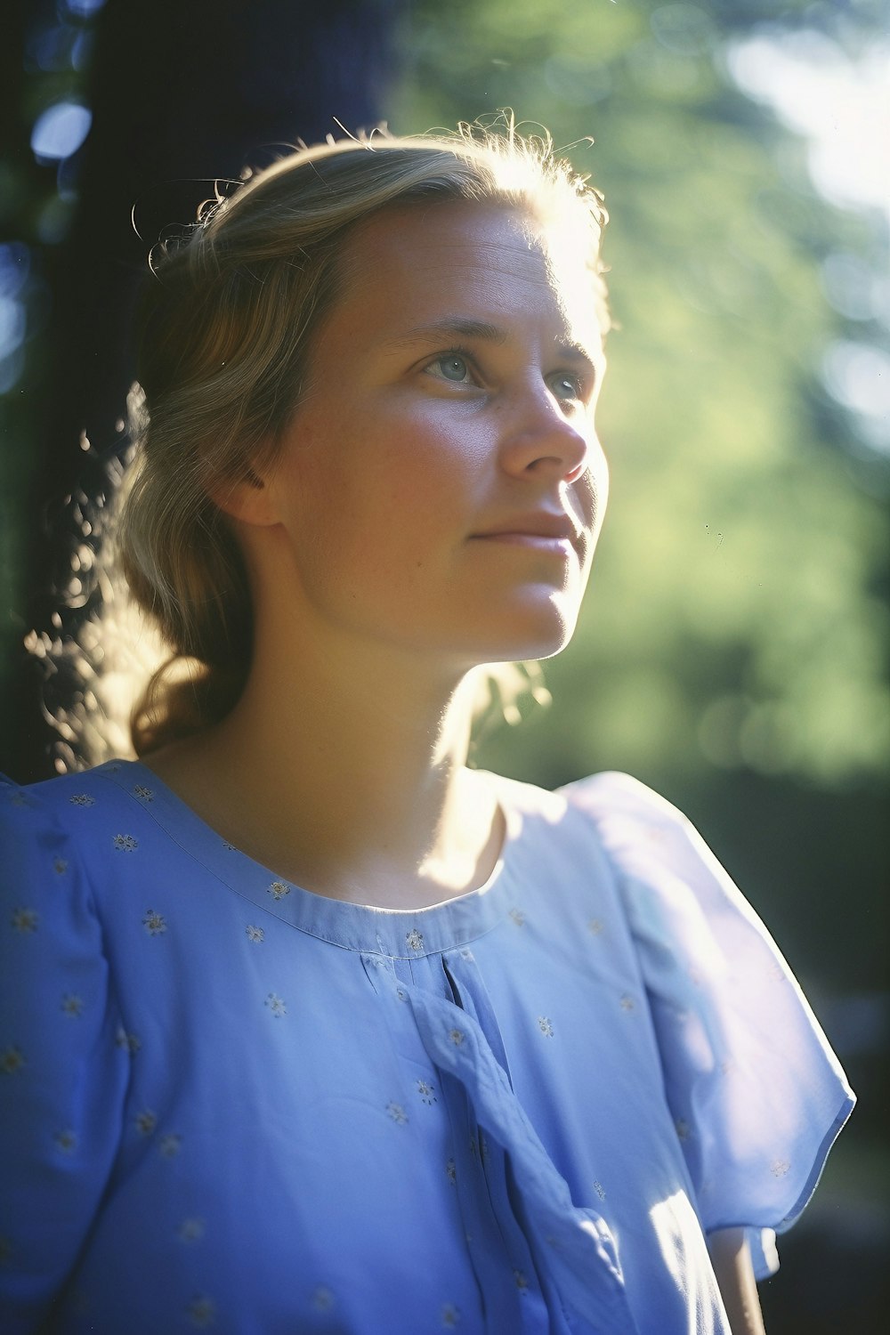 a woman in a blue dress looking off into the distance