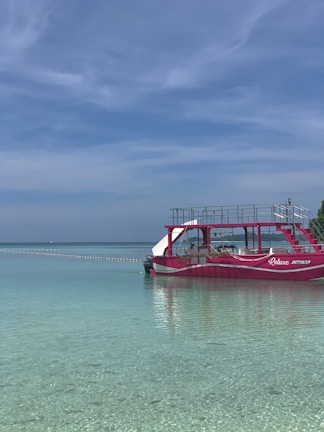 A serene turquoise pontoon floating on the vibrant waters of Bacalar's lagoon at sunrise.