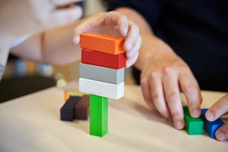 a child playing with a stack of blocks