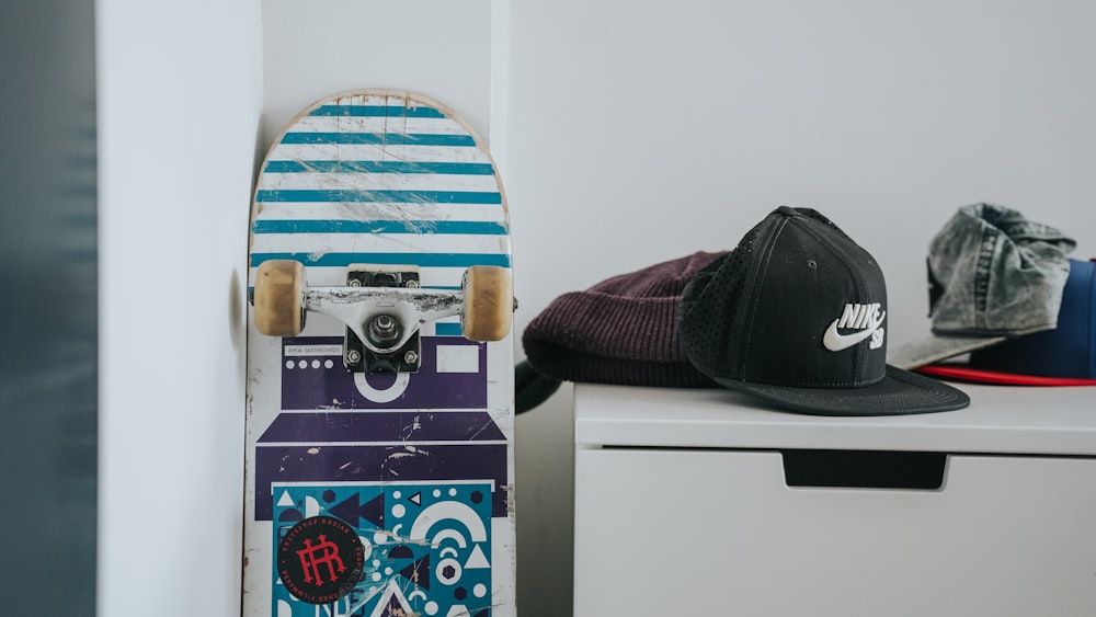 a skateboard and a hat on a shelf