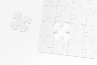 a piece of white puzzle sitting on top of a table