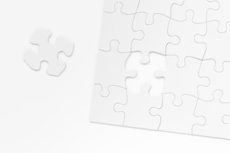 a piece of white puzzle sitting on top of a table