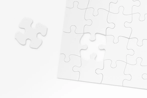 a piece of white puzzle sitting on top of a table
