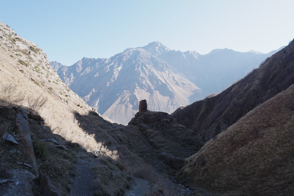 a view of a mountain range from the top of a hill