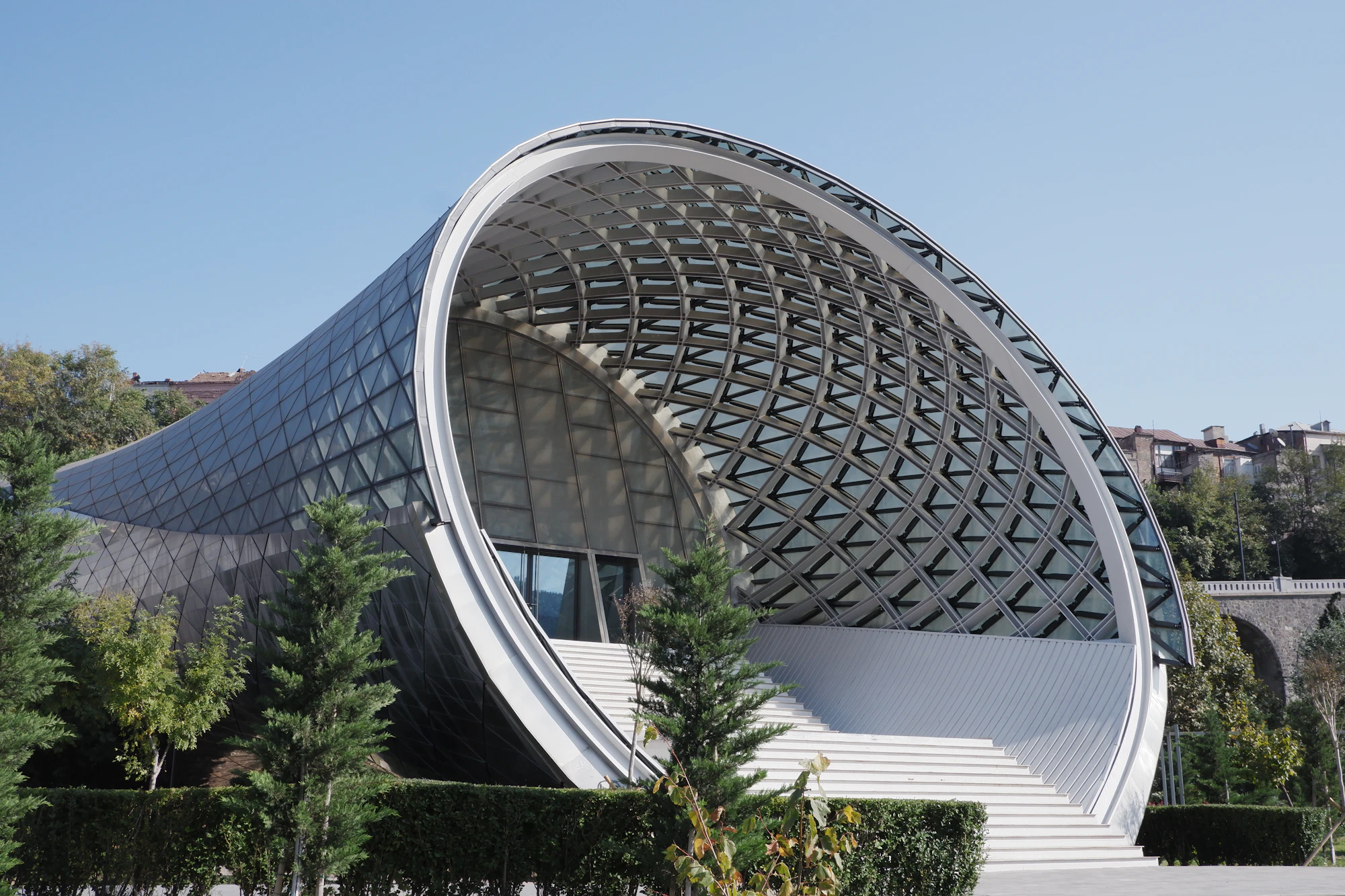 A curved open-air stage with a lattice roof