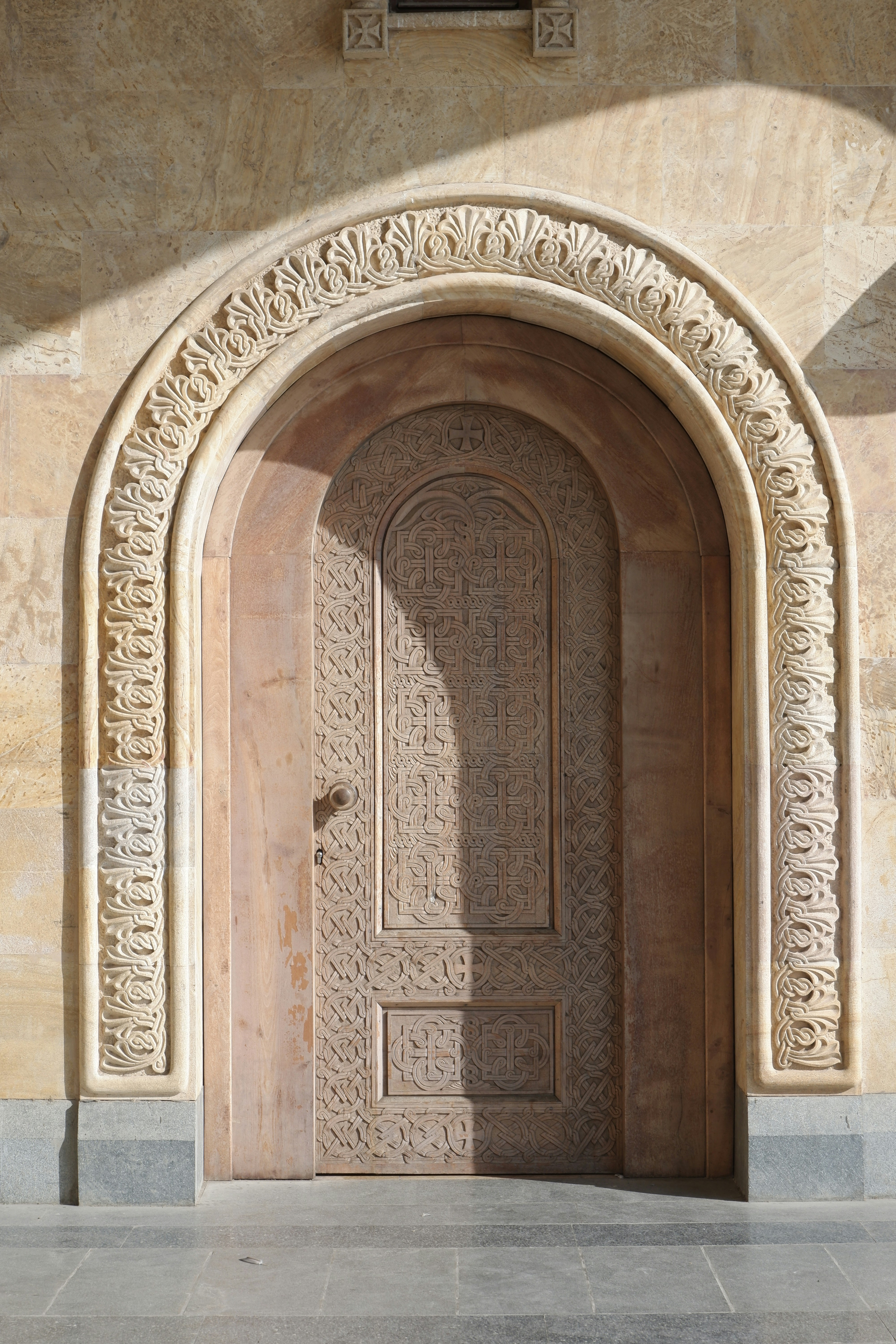 a doorway with a stone arch and a clock on the wall
