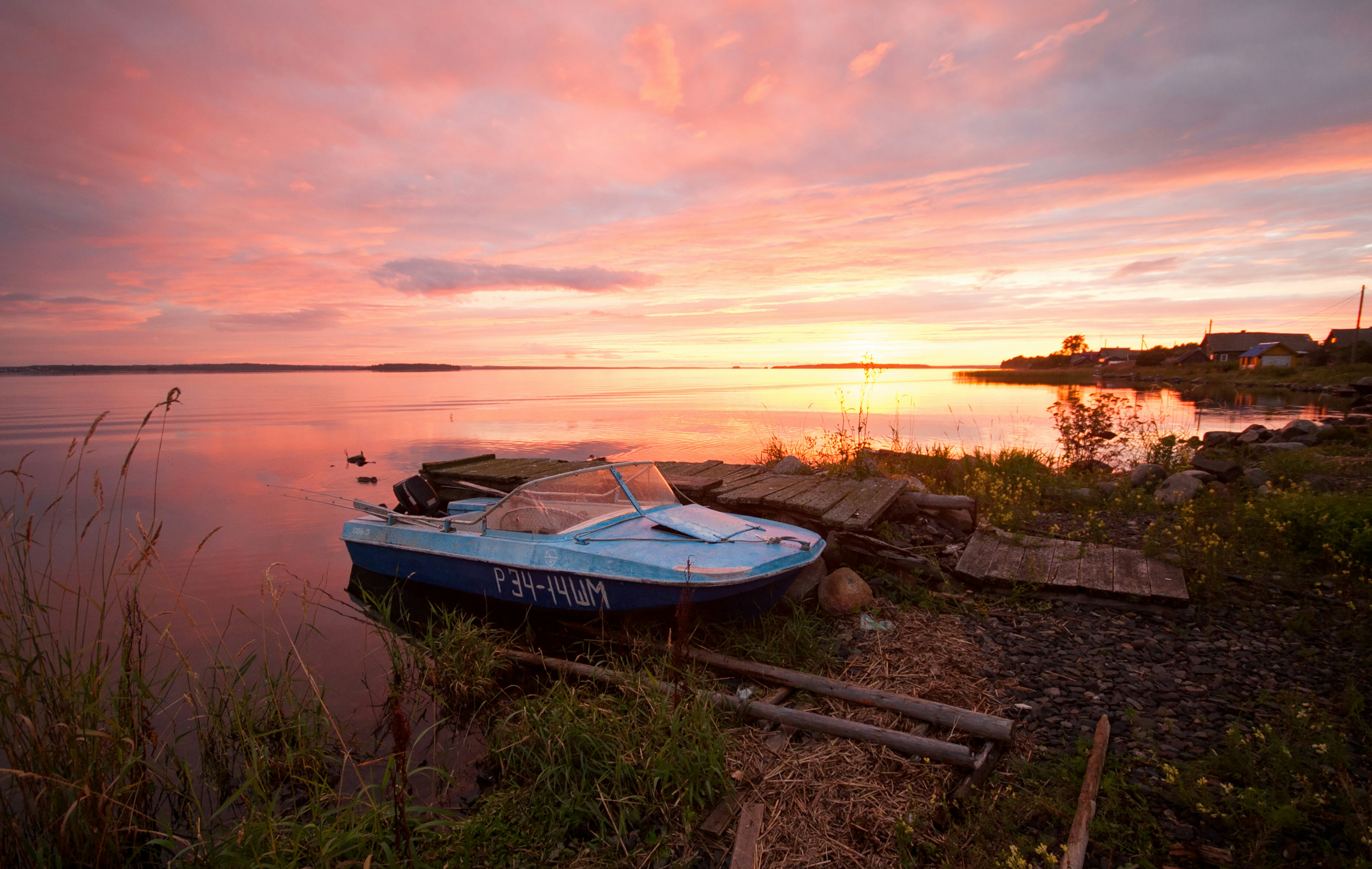 a blue boat sitting on top of a body of water