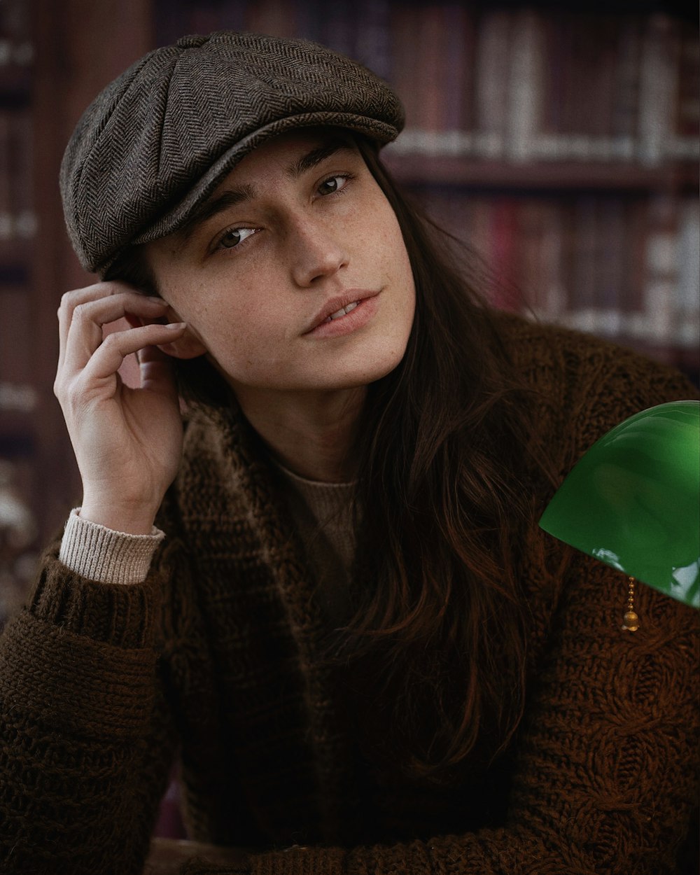 a woman in a brown sweater and a brown hat