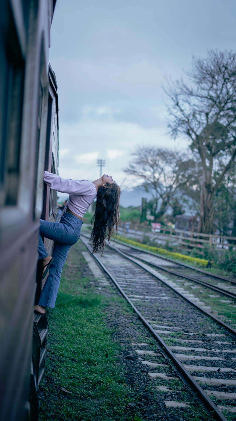 a woman leaning out of a train window