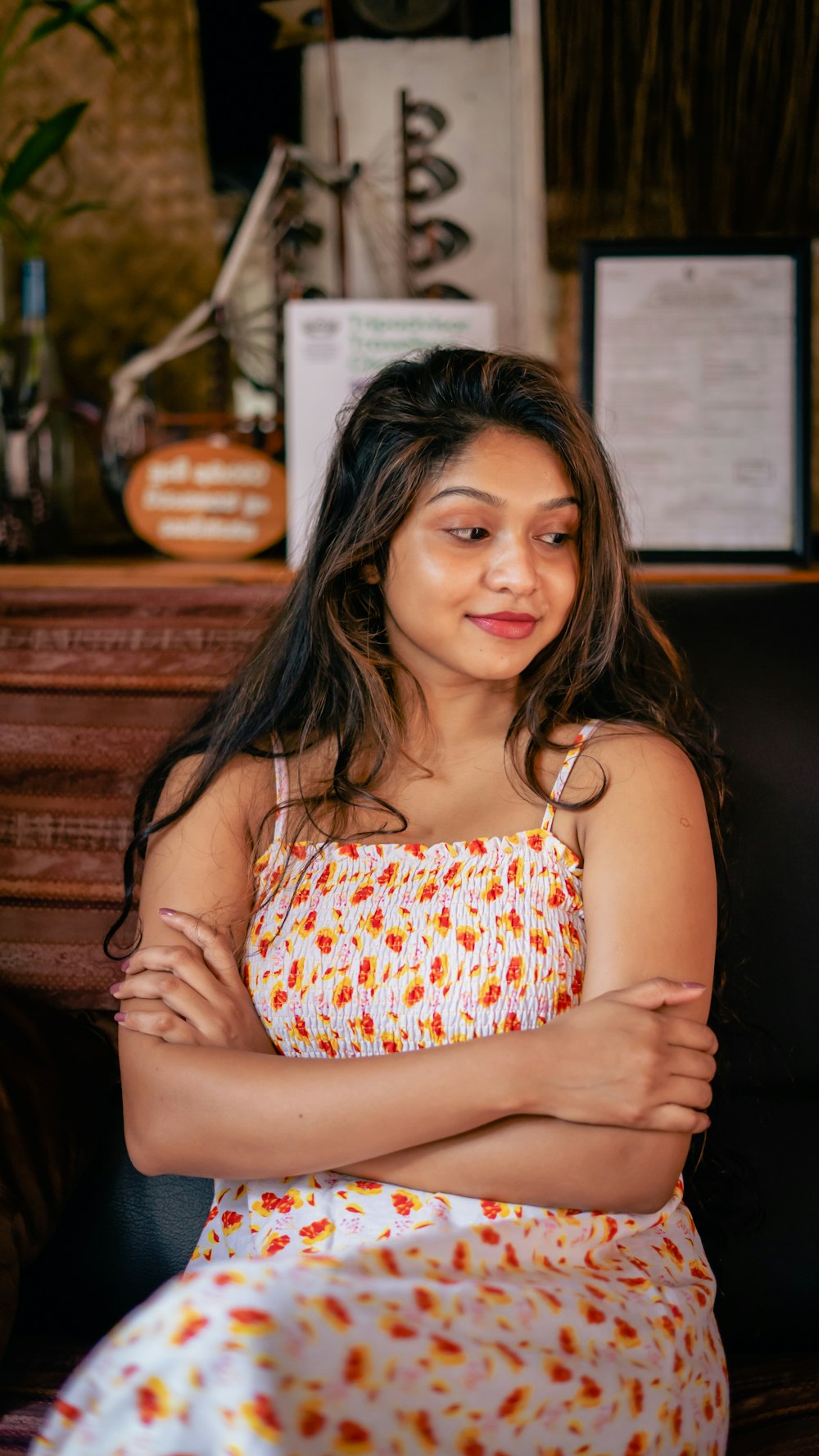 a woman sitting in a chair with her arms crossed