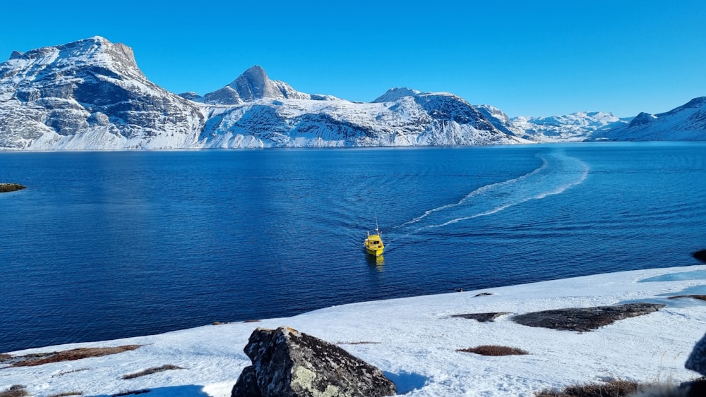 a man in a yellow life jacket is in the water